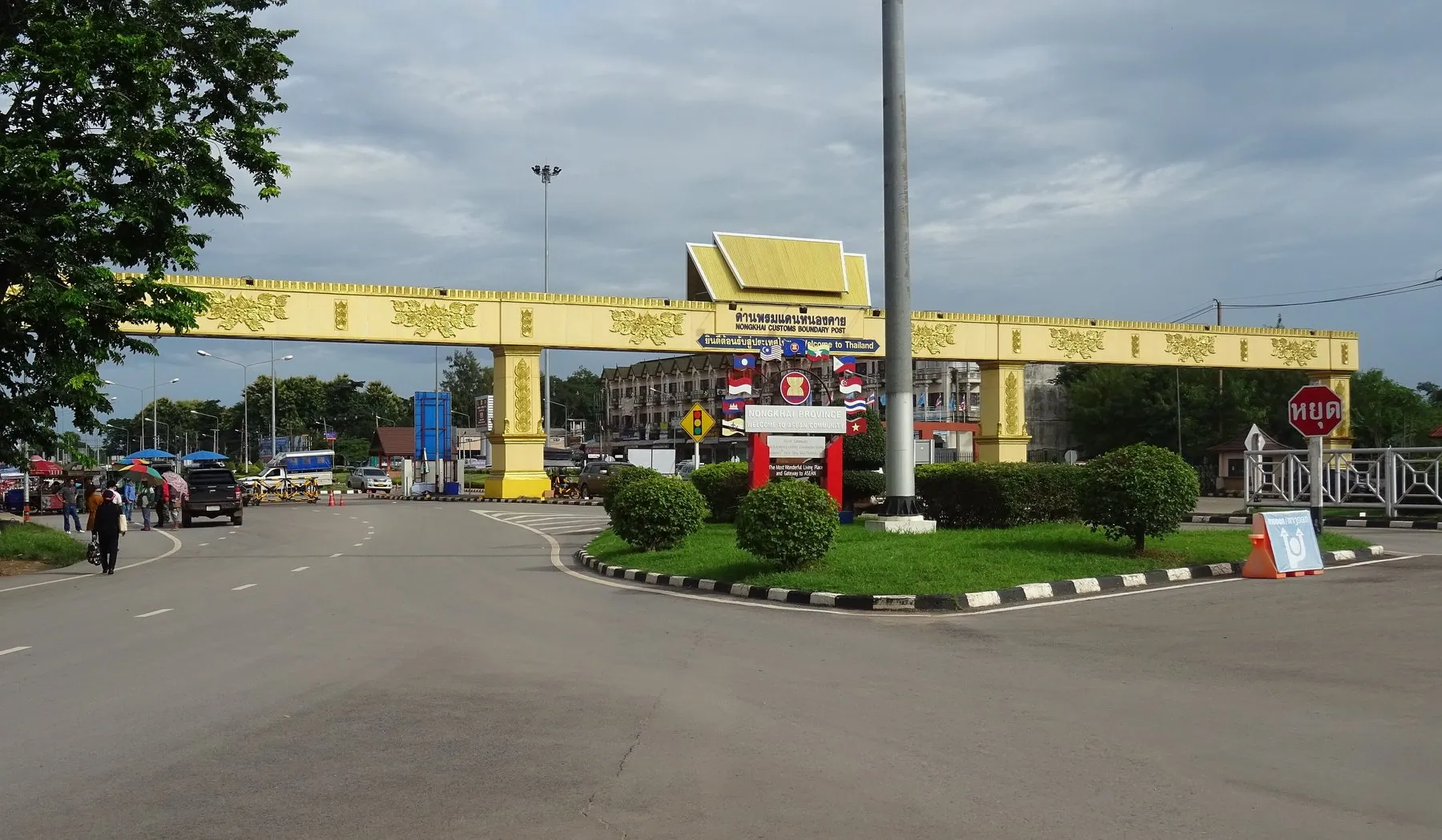 A yellow customs gantry lettered in Thai spanning the empty approach road at the Nong Khai border post on the Thai side of the Friendship Bridge