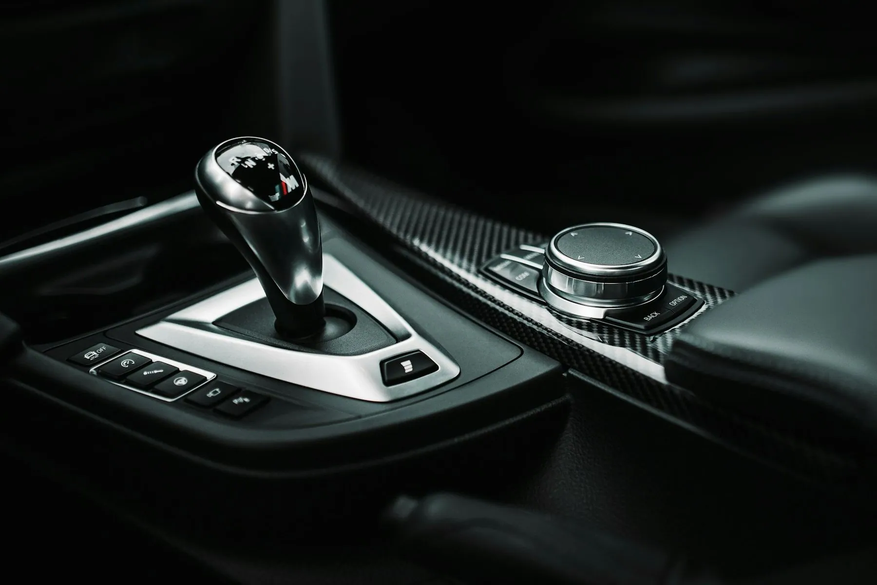 Close-up of an automatic gear selector on a dark centre console