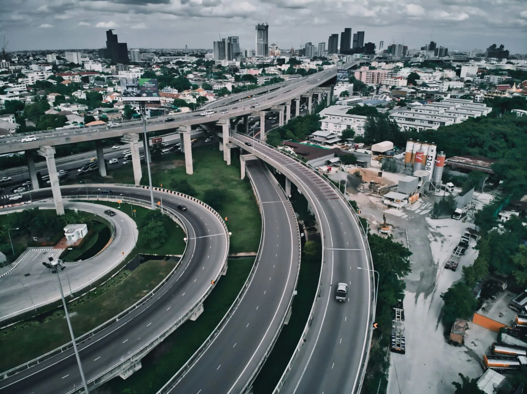 Aerial view of a multi-level expressway interchange curving through a city