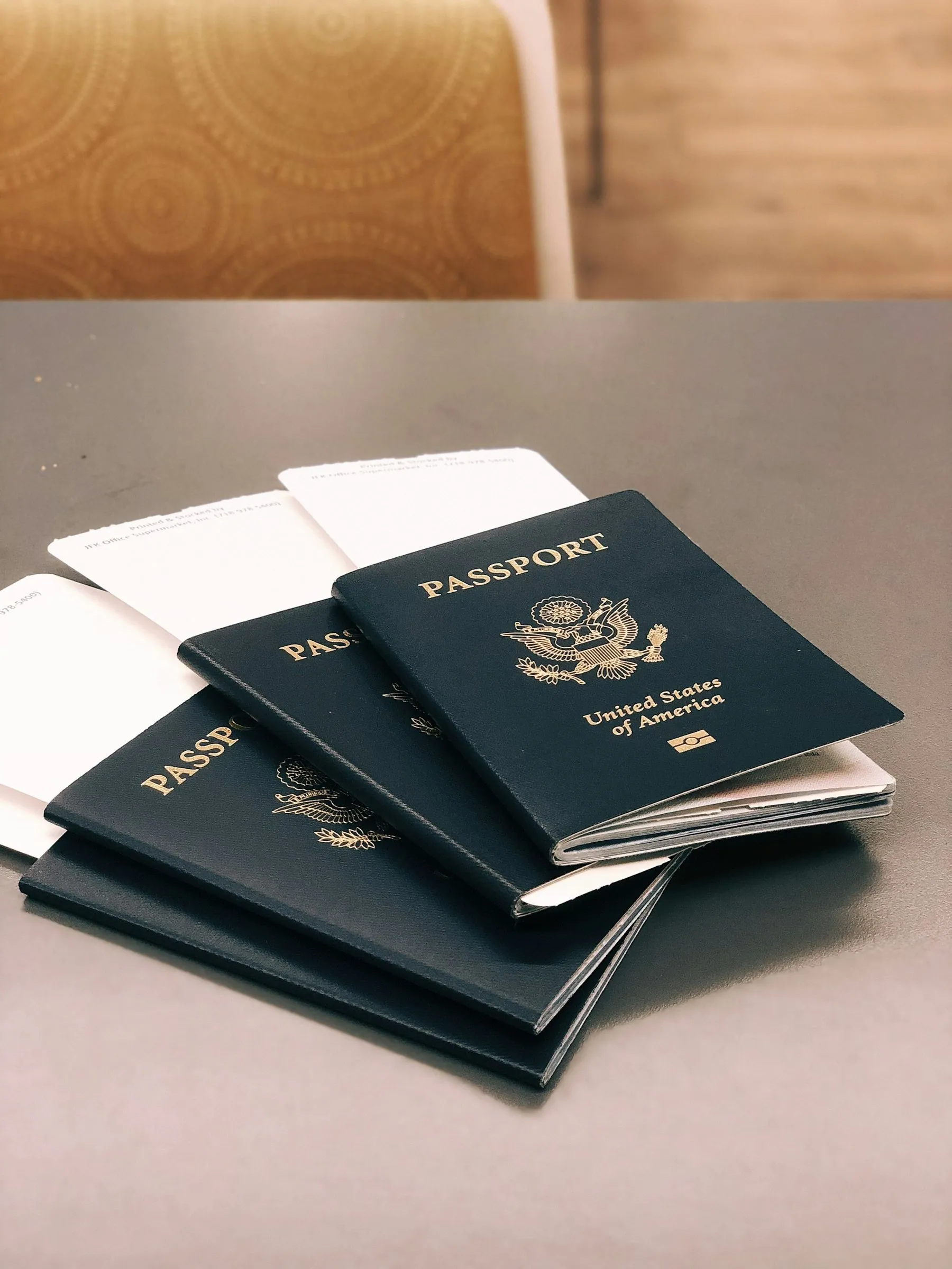 Four passports fanned out on a wooden table