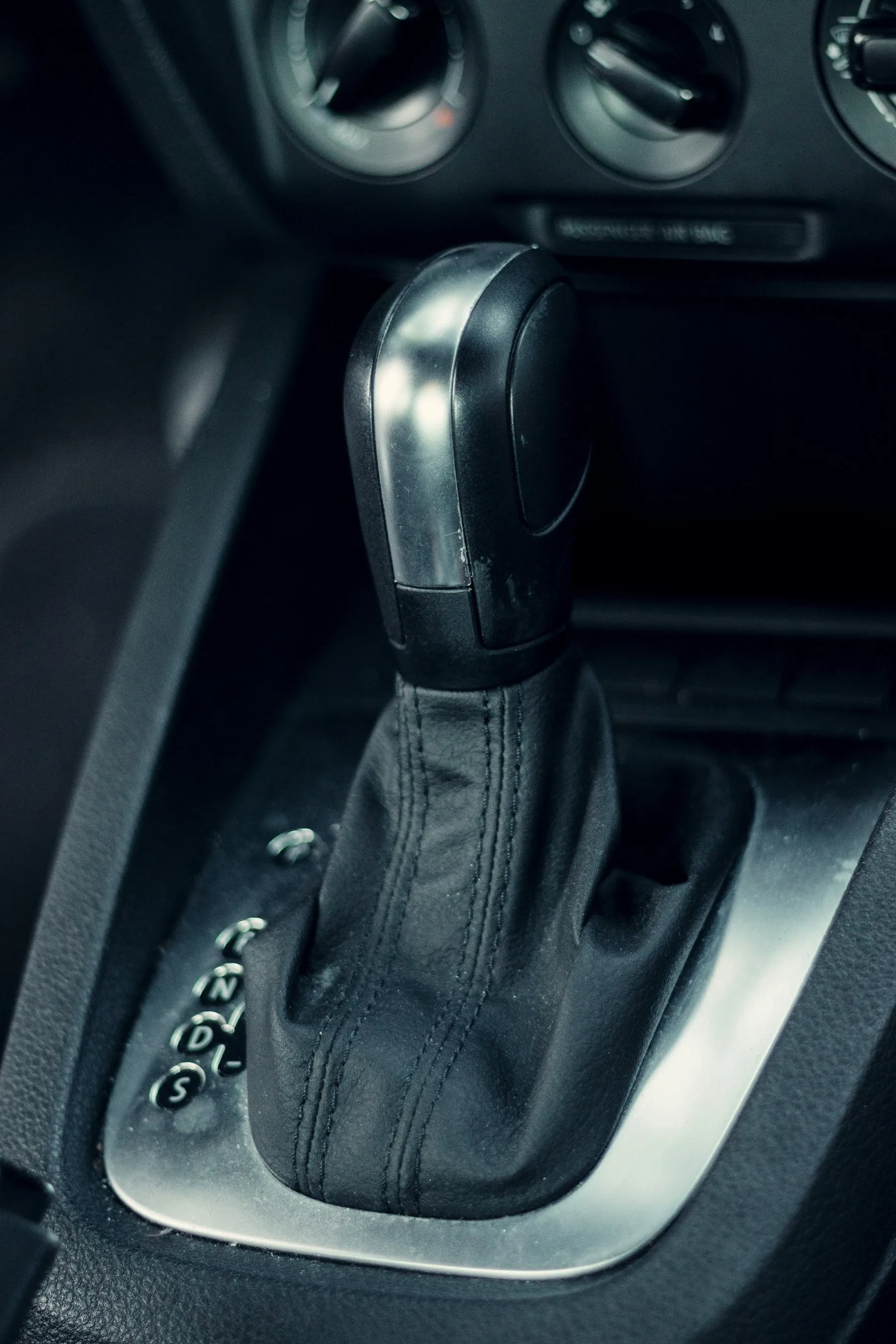 An automatic gear selector in a car's centre console, in the park position