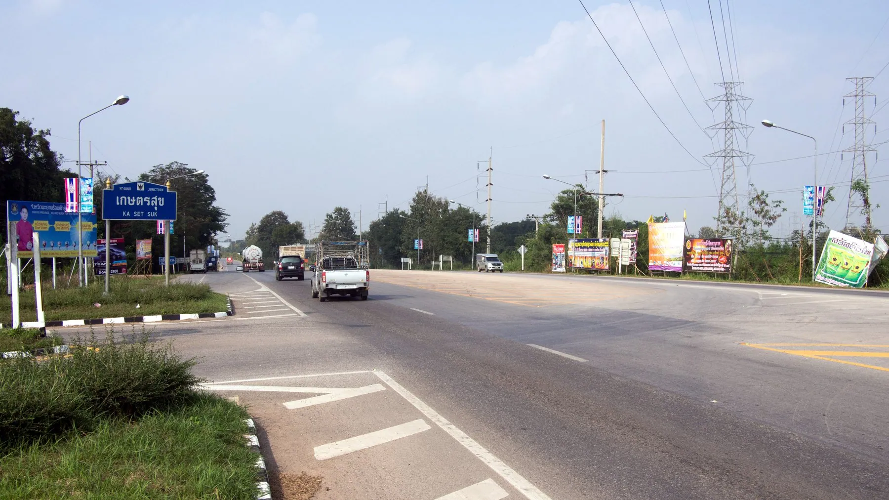 Highway 1 heading north from the Ka Set Suk junction in Lampang province, wide carriageway and roadside signs