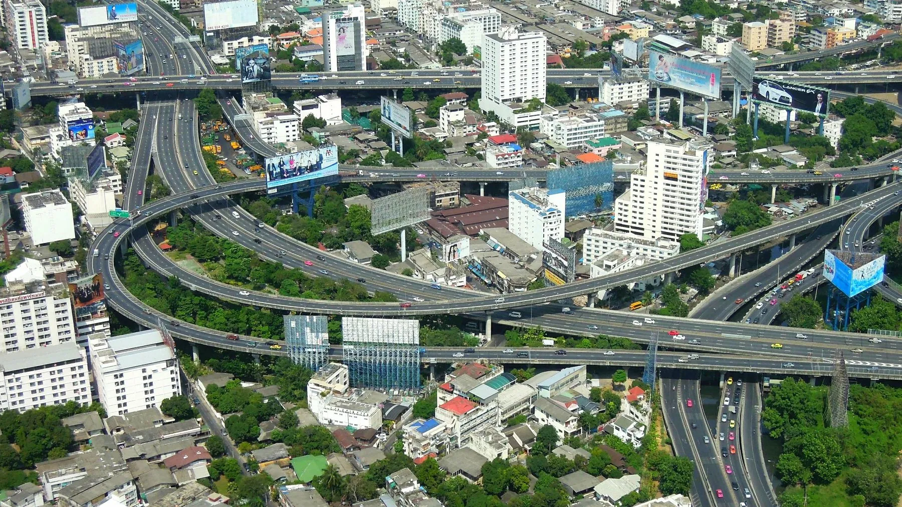 Looking down on Bangkok's stacked elevated expressways curving over the rooftops