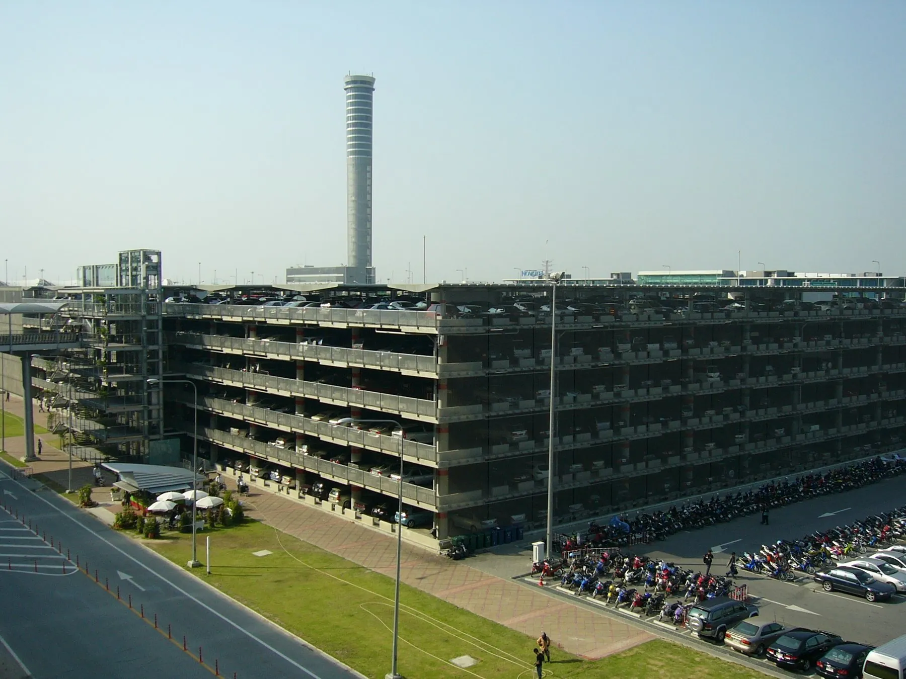 The multi-storey car park at Suvarnabhumi airport, rows of vehicles visible on every open deck