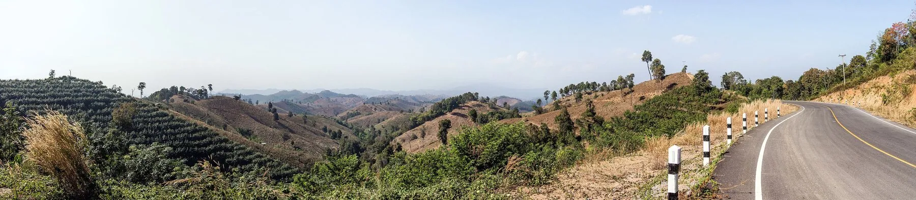A back road on a ridge in Na Muen district, Nan province, with wooded mountains falling away on both sides