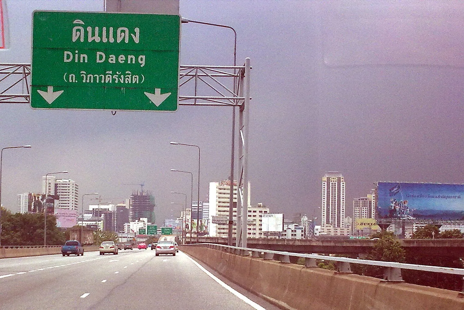 An elevated Thai expressway curving away above the city towards Din Daeng
