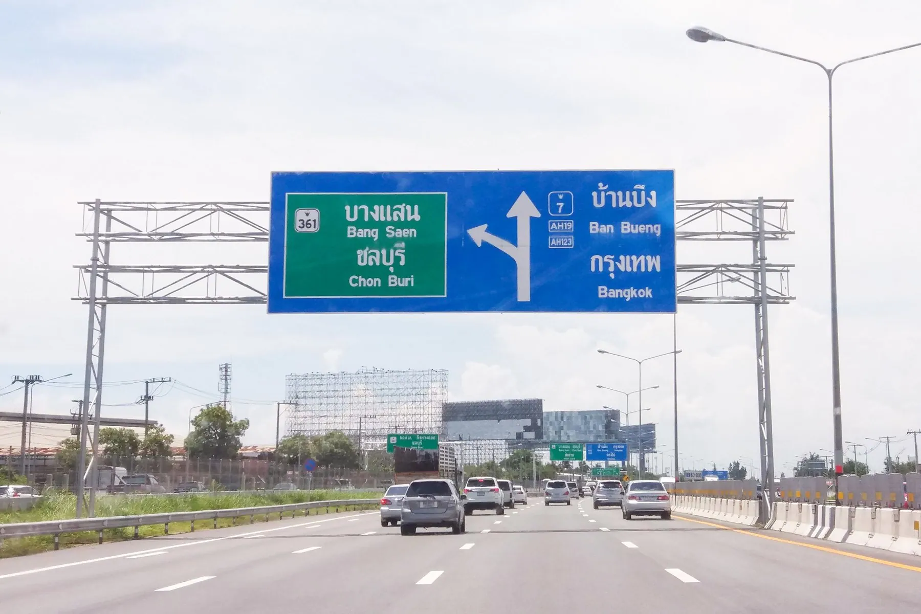 Overhead motorway gantry signs in Thai and English at the Khiri Nakhon interchange on the road to Bangkok