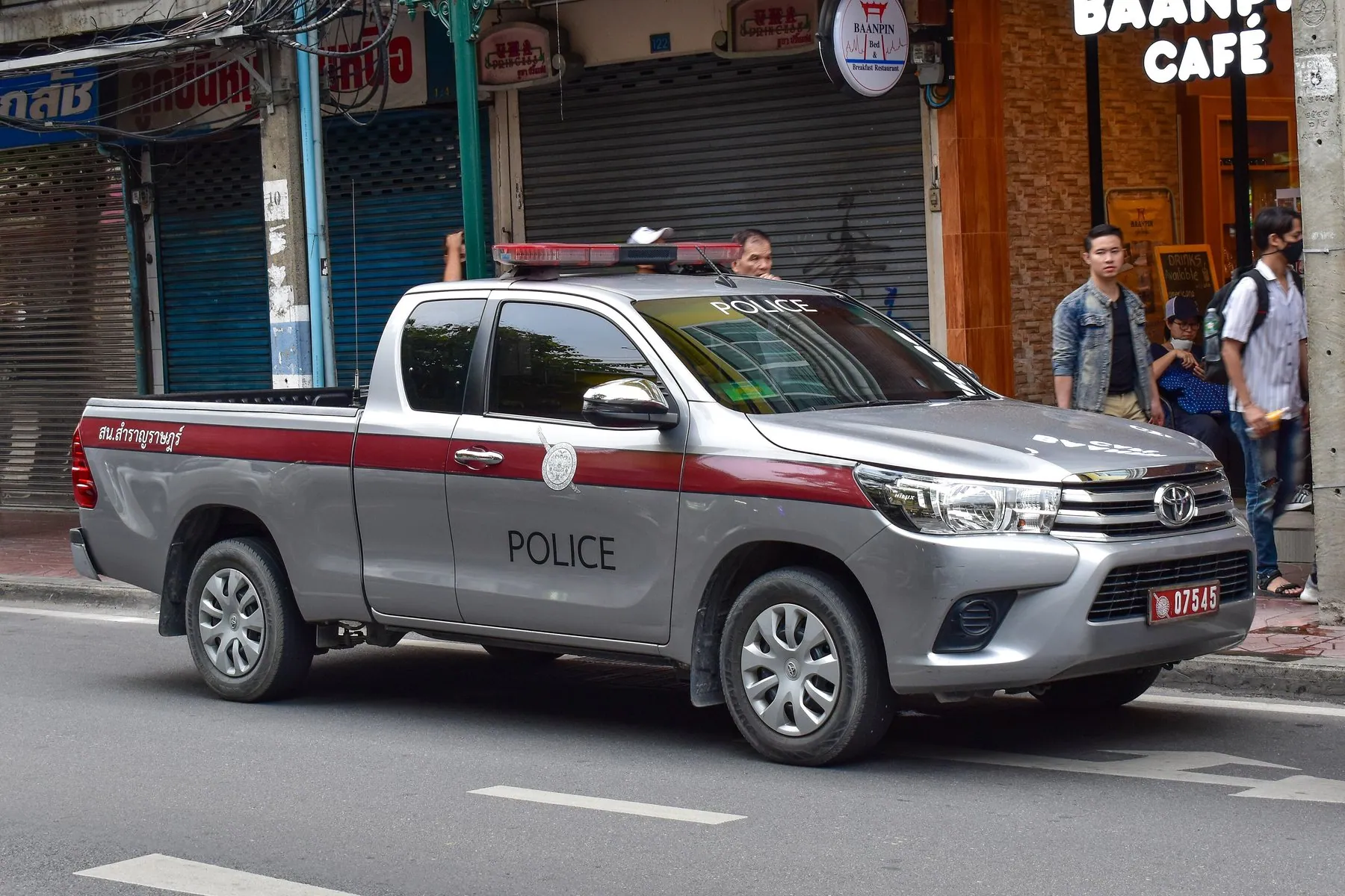 A Royal Thai Police traffic Toyota Hilux in Metropolitan Police livery parked at the kerb