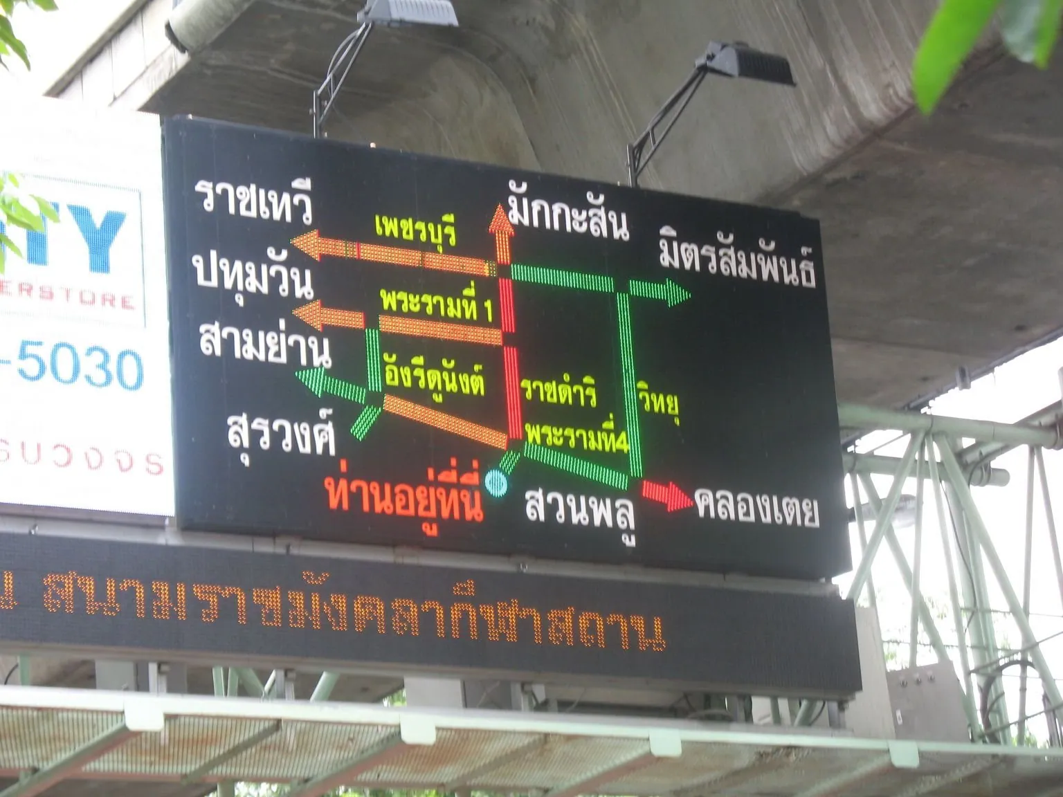 Rush-hour traffic packed across Silom Road in Bangkok with motorbikes filling the kerbside lane