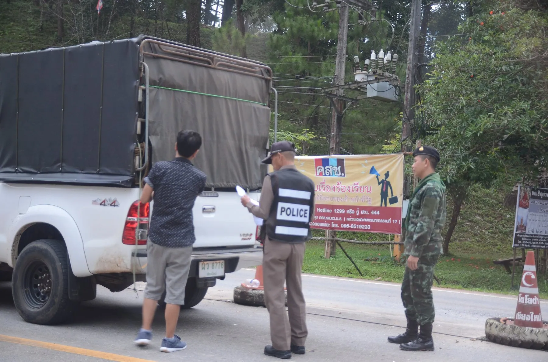 A roadside police check on the highway south of Chiang Rai seen from a passing vehicle