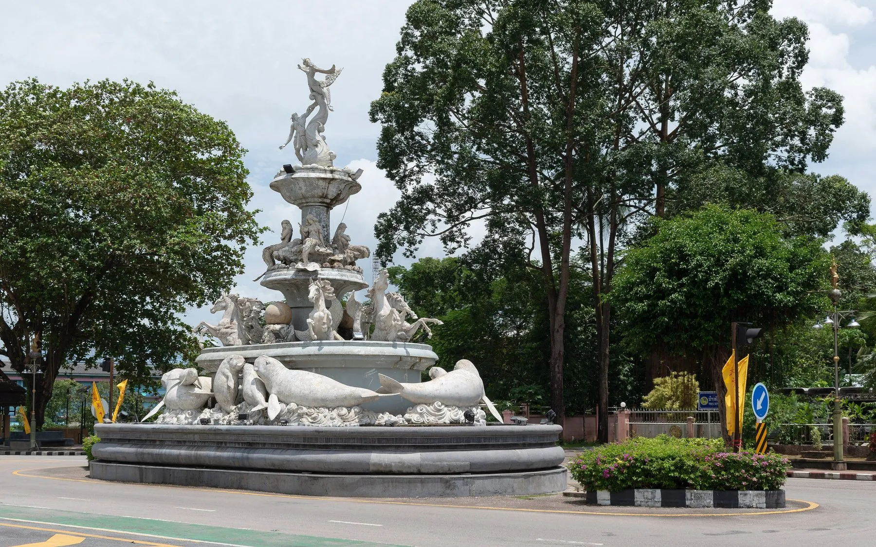 The dugong fountain roundabout in Trang town with traffic circling the island
