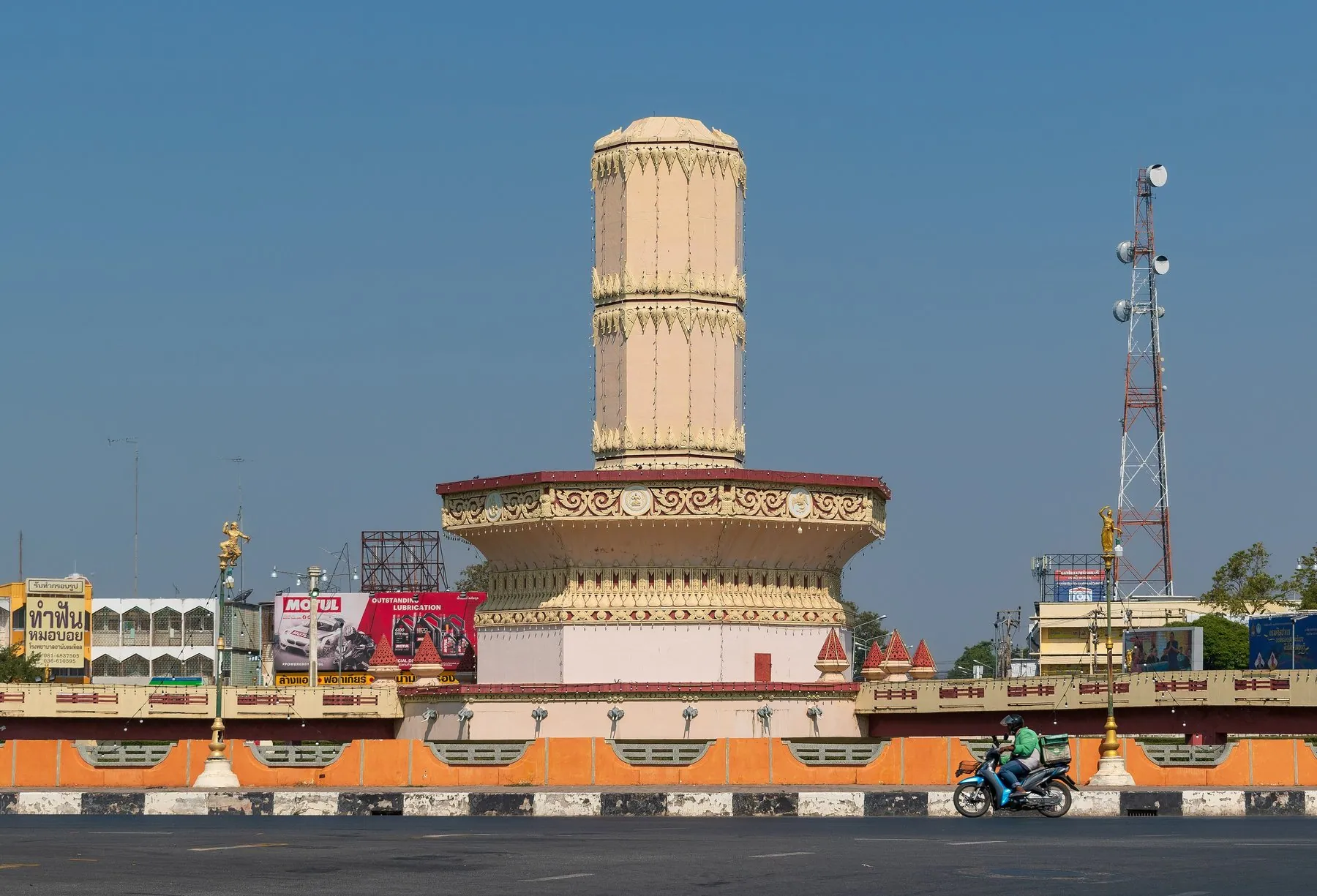 A motorcyclist rides around the Si Suriyothai roundabout in Lopburi past its central monument