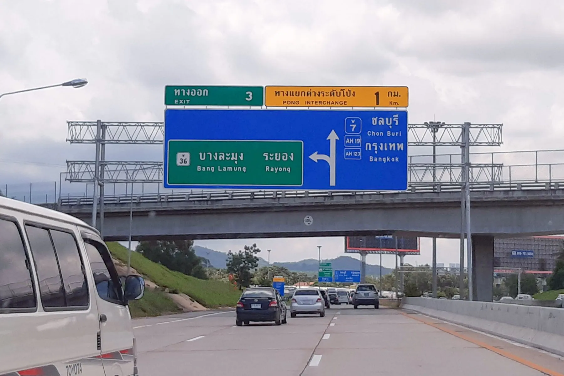 Large green direction signs lettered in Thai and English above the Pattaya interchange