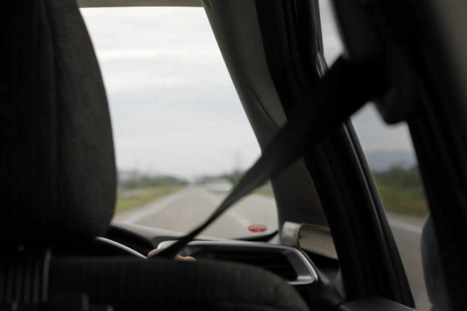 The road ahead seen from the driver's seat through a car windscreen