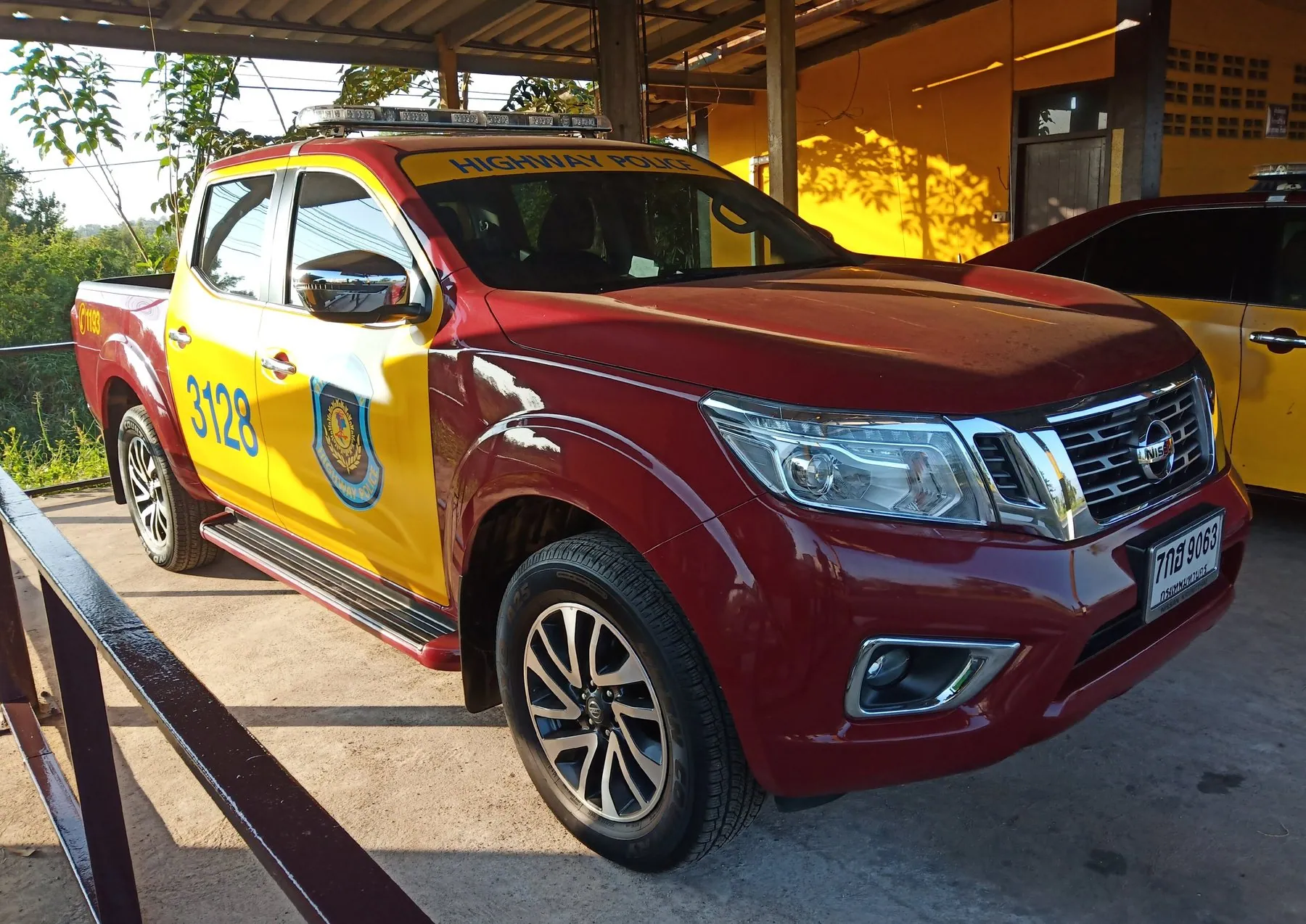 A Thai Highway Police Nissan Navara pickup parked outside a highway police box
